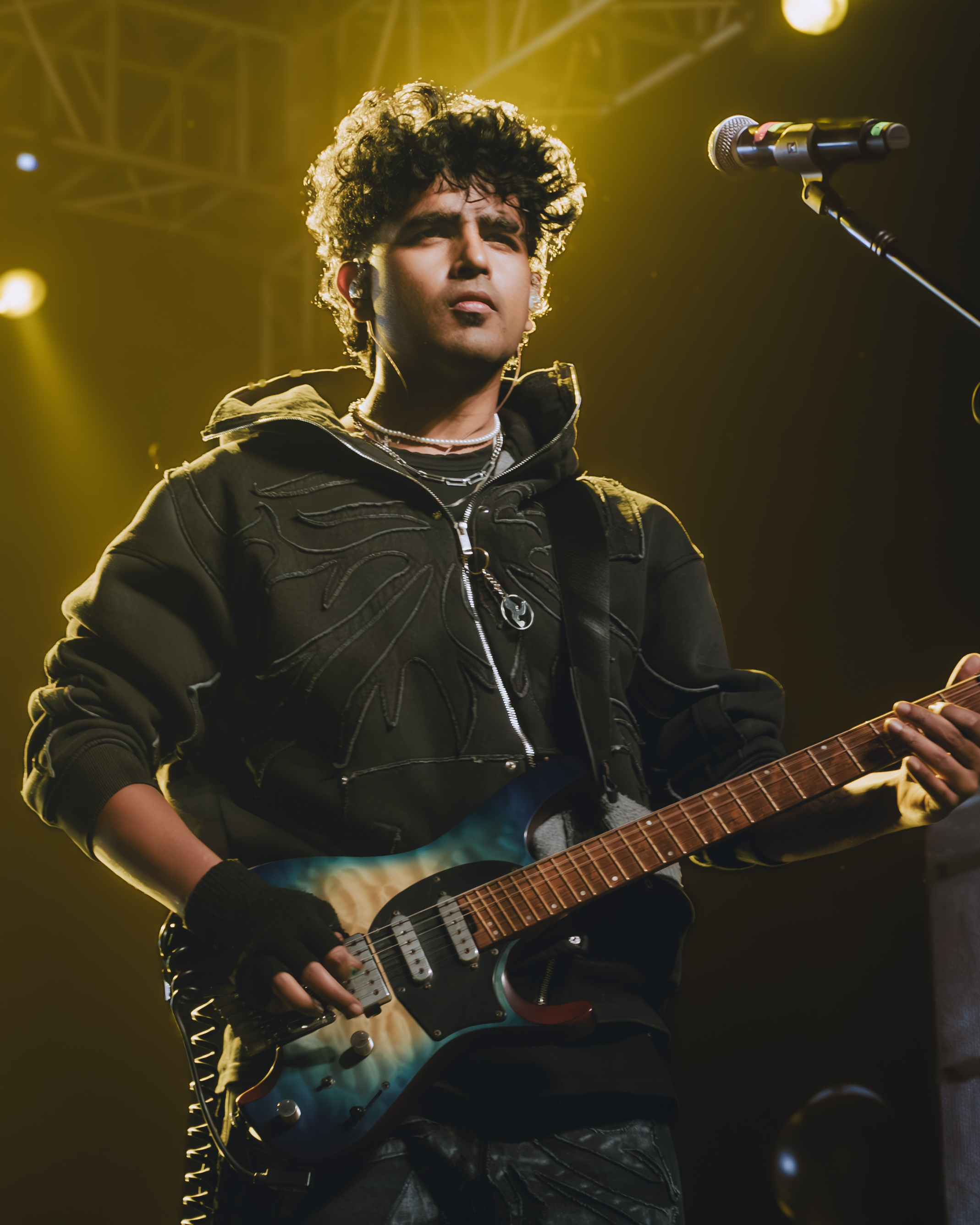 Sabali guitarist performing under warm stage light
